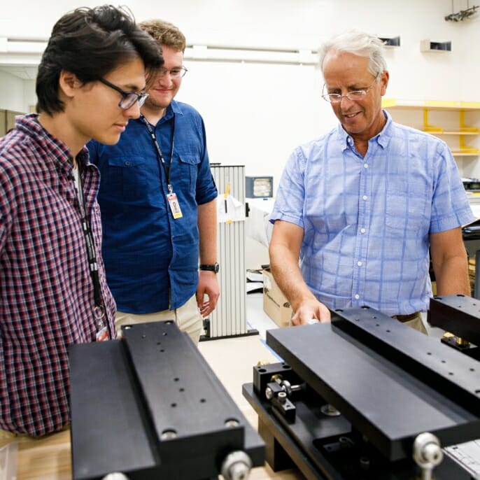 CXFEL Labs Chief Scientist William Graves discusses the CXFEL with two students