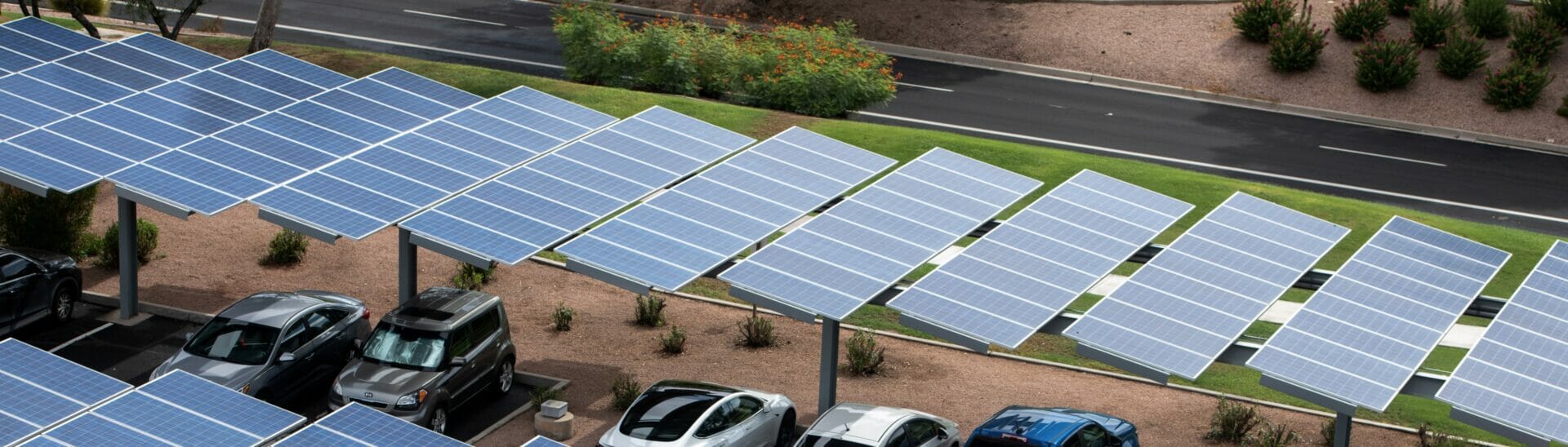 Aerial view o solar panels that provide shade for cars parked beneath them